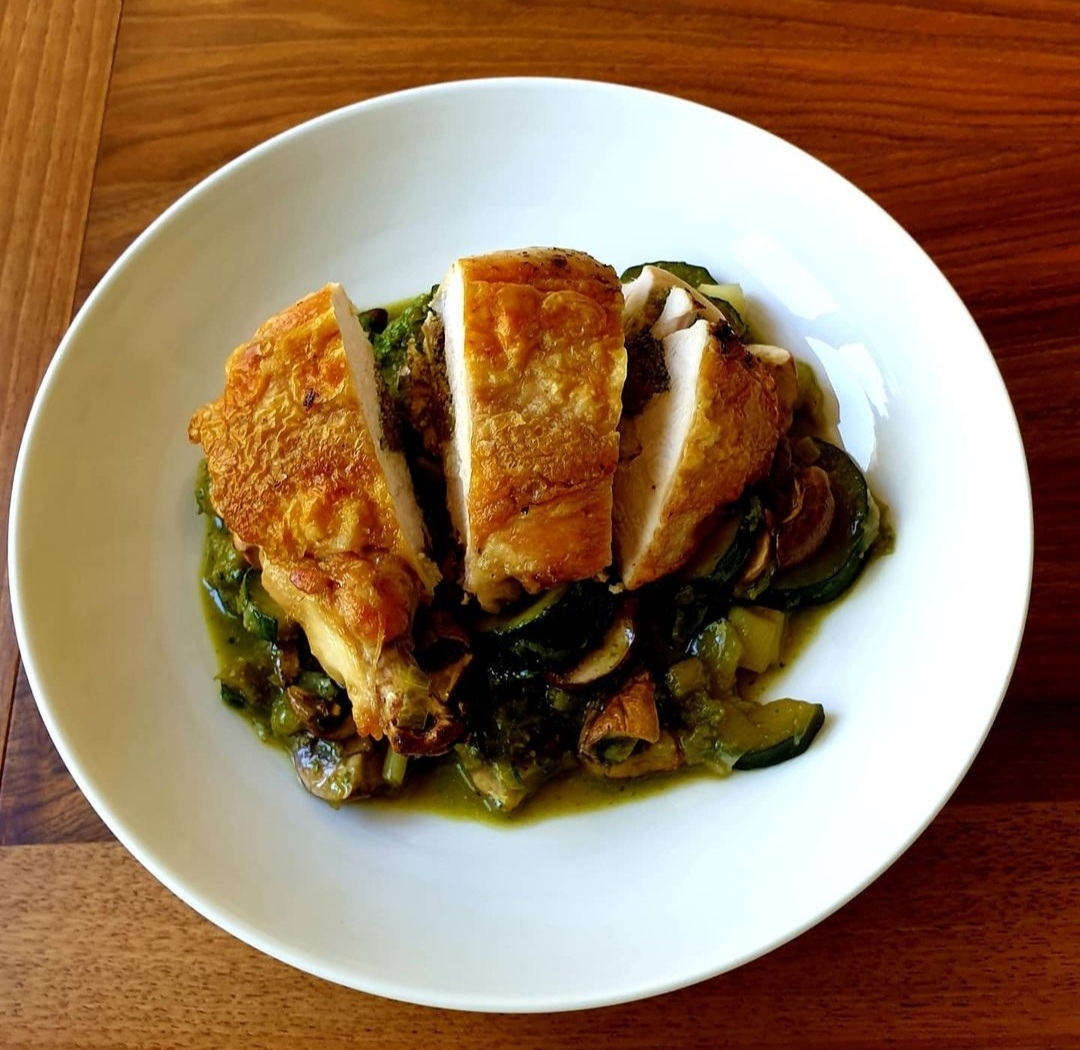 Pesto, feta and olive stuffed chicken supreme on a bed of leeks, courgette, mushrooms and more pesto